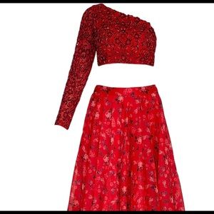 Red lengha with beautiful one shoulder blouse.